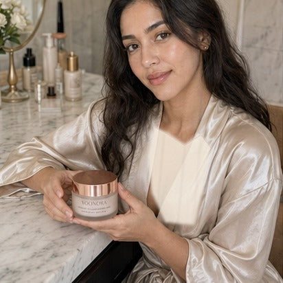 Creator holding YOONORA Overnight Glow Mask with covered robe styling