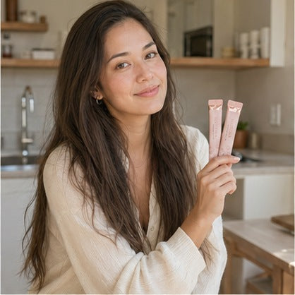Creator holding two YOONORA Collagen Jelly Stick packets